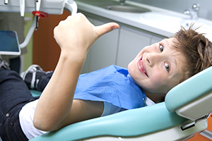 Kid Smiling in Dental Chair