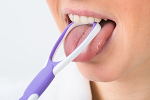 Woman Using Tongue Scraper